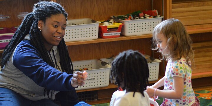 Teacher playing with children